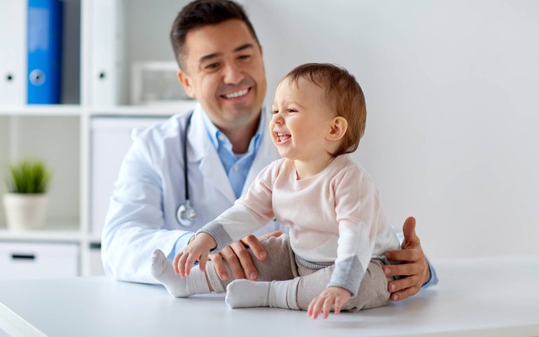 happy-doctor-or-pediatrician-with-baby-at-clinic-2022-12-16-09-45-00-utc.jpg